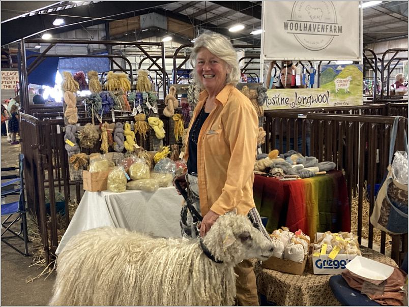 June Colony, of Lostine Long Wool, Lostine, Oregon, shows her sheep in her vendor booth. Photo: Evelyn Taylor.